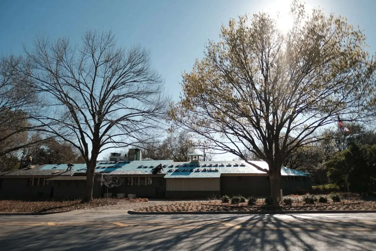 Arrington Roofing crew installing a synthetic shake roof in Kessler Park, Dallas